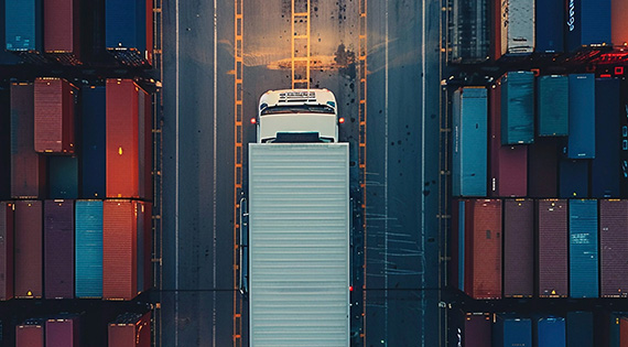 Truck driving between containers